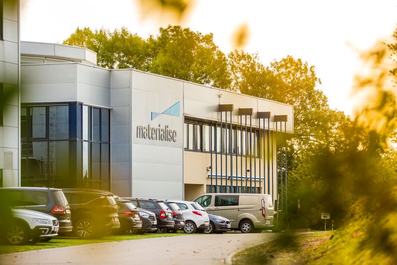 View of Materialise headquarters exterior through leaves 